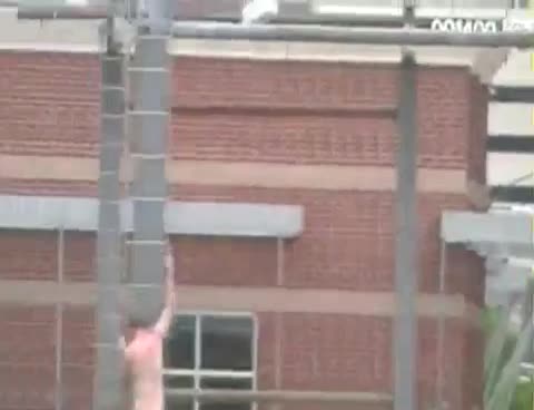 Naked Man Climbs Down From Billboard