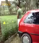 Lad Takes A Piss Behind A Car