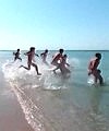 Group Of Men Run Into Seaa